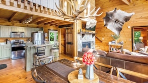 A wooden cabin interior with a dining area, kitchen, and living room. - Family-Friendly Blue Ridge Log Cabin w Stunning Views-Free Flexible Check In-Out (Blue Ridge)