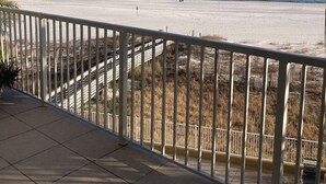 A balcony with a view of a beach and ocean. - Beautiful and Spacious Beachfront Rental! Beach Chair Service Included! (Orange Beach)