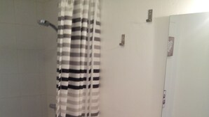 A bathroom with a shower, a sink, and a mirror. - WATERFRONT STUDIO APARTMENTS CARNON PLAGE NEAR LA GRANDE MOTTE (CARNON PLAGE)