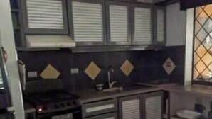 A compact kitchen with a gas stove, a sink, and storage cabinets. - Pelicano Loft House (Esterillos Este)