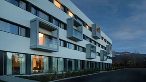 A modern hotel with multiple balconies, large windows, and a well-maintained exterior. - AC Hotel Saint-Julien-en-Genevois (Saint-Julien-en-Genevois)