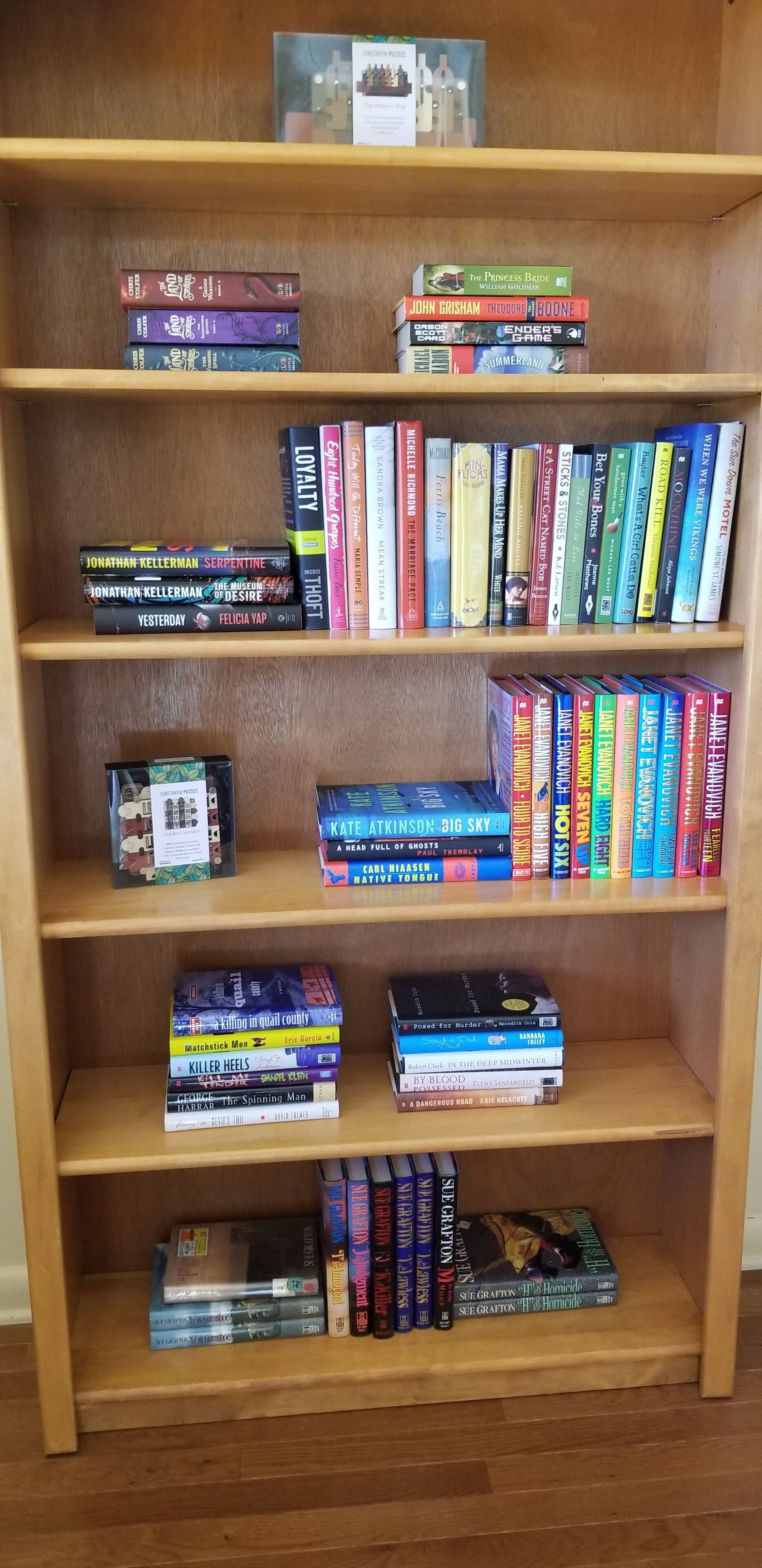 A bookshelf with various books.
