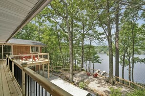 A wooden deck with a view of a lake surrounded by trees. - Large, 4 season, lakefront retreat. Close to skiing, golf and hiking. (Newton)