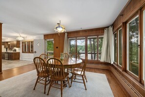 Enjoy meals in this dining area with a large round table and comfortable seating for all.