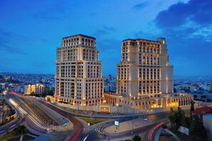 A large, multi-story hotel with a grand entrance and a prominent clock tower.