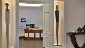A reception area with a reception desk, a television, and a sign that reads "Club Lounge".