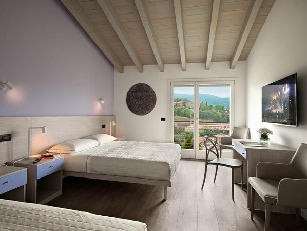 Deluxe Triple Room, Kitchenette | Minibar, in-room safe, desk, blackout curtains