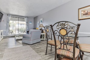 Relax in a spacious living area with a comfortable sofa and armchair, perfect for reading or dining.