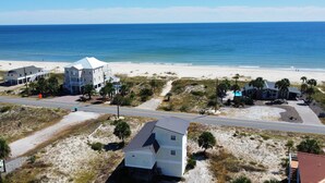 A coastal property with a large house, a smaller building, and a beach. - Welcome to Catbird Seat! (St. George Island)