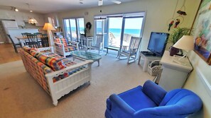 Relax in this ocean-view living area with a sofa, armchair, and coffee table.