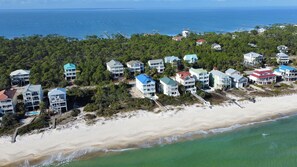 An aerial view of a coastal resort with beachfront properties, including multi-story buildings with balconies and a beach access walkway. - Private Pool! Easy Beach Access! (St. George Island)