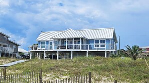 Enjoy stunning ocean views from the spacious balcony of this beachfront house.