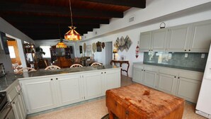 A spacious kitchen with white cabinets, a wooden island, and a patterned rug. - Sandy Beach: 3  BR, 3  BA House in St. George Island, Sleeps 8 (St. George Island)