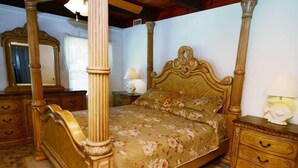 A four-poster bed with floral bedspread, wooden nightstands, and a mirror. - Sandy Beach: 3  BR, 3  BA House in St. George Island, Sleeps 8 (St. George Island)