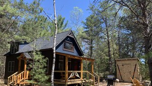 A cabin with a porch, a deck, and a shed. - Brand new cabin in the Adirondacks near Whiteface Mountain! (Wilmington)