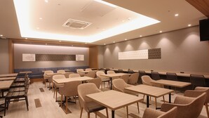 A conference room with tables and chairs, a blue sofa, and a patterned wall. - Sapporo Washington Hotel Plaza (Sapporo)