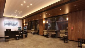 A modern reception area with a reception desk, seating area, and a large window with blinds. - Sapporo Washington Hotel Plaza (Sapporo)