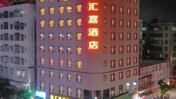 A hotel with multiple floors and a prominent sign.