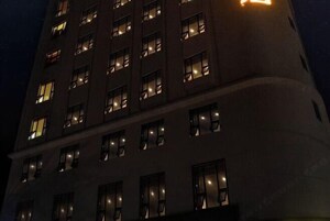 A multi-story building with illuminated windows at night.
