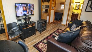 A cozy living room with a television, a fireplace, a sofa, and a coffee table. - 2 Bedroom with Great View from Wrap-Around Deck (Estes Park)