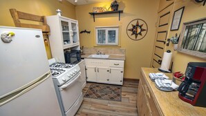 A compact kitchen with white cabinetry, a stove, and a sink. - 2 Bedroom with Great View from Wrap-Around Deck (Estes Park)