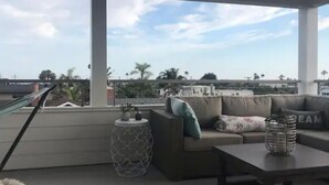 A spacious living area with a large window, a sofa, a coffee table, and a small side table.