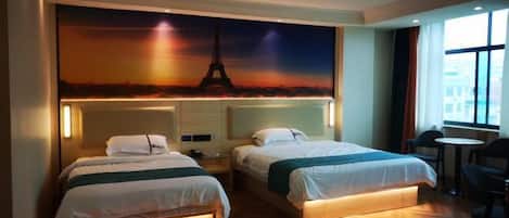 A hotel room with two beds, a large mural of the Eiffel Tower, a small table, and a chair.