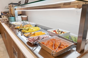 A buffet with various food options including fruits, cheeses, and meats. - Sudima Kaikoura (Kaikoura)
