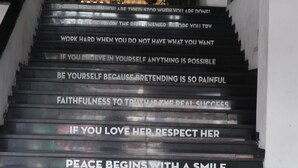 A staircase with motivational quotes on the steps. - Best Hotel (Surabaya)