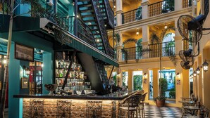 A multi-level atrium with a checkered floor, a bar area, and outdoor seating. - Quba by Montraj Pattaya, previously The Quba Hotel Pattaya (Pattaya)
