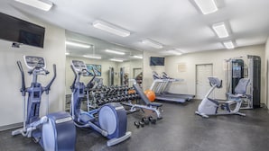 A gym with various exercise equipment, including treadmills, elliptical machines, and free weights. - Scottsdale Condo - Great Location, Pool, Full Kitchen (Scottsdale)