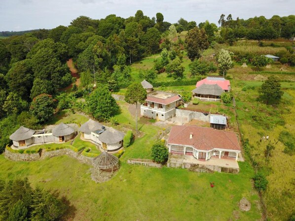 A rural area with several houses surrounded by lush greenery and trees. - Kilima Resort (Iten)