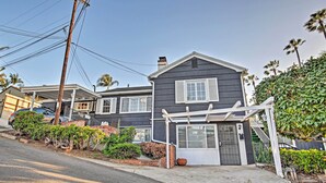 A two-story house with a covered porch, a garage, and a driveway. - Quaint La Mesa Home with Beautiful Sunsets! (La Mesa)