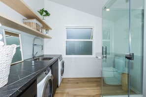 Bathtub, hair dryer, towels, toilet paper