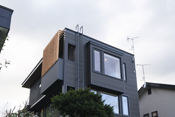 A modern two-story building with a flat roof and large windows. - Furano Sanso (Furano)