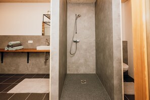 A bathroom with a shower, sink, and toilet. - Vacation cottage FuchsbAU, Austria (Au)