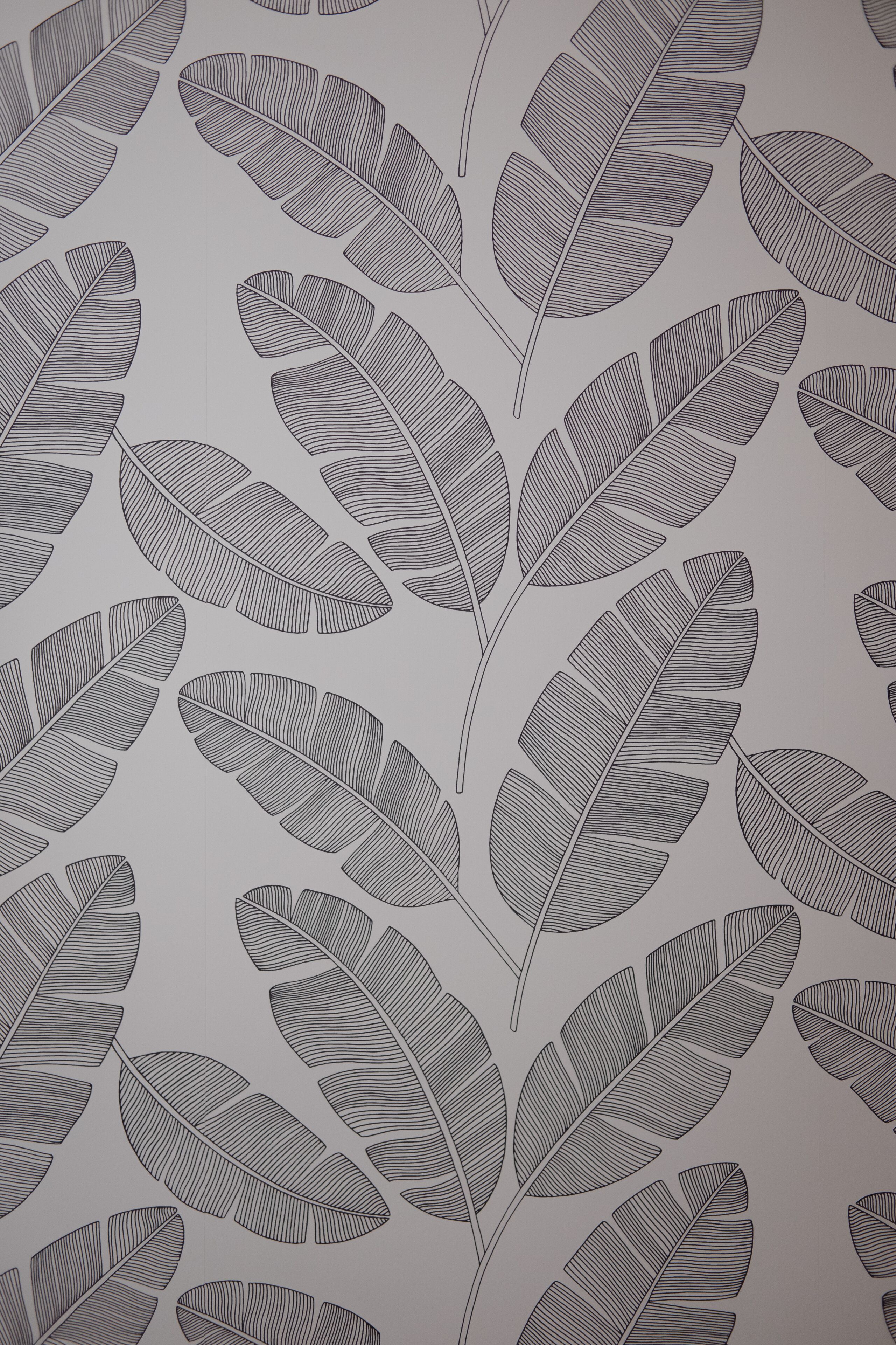 Un motif composé de dessins évoquant des feuilles, répété sur une surface.