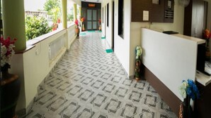 A hotel reception area with a patterned floor, a reception desk, and a sign indicating the 'SUMMIT' room. - Saanvi Resort Bhavnagar (Bhavnagar)