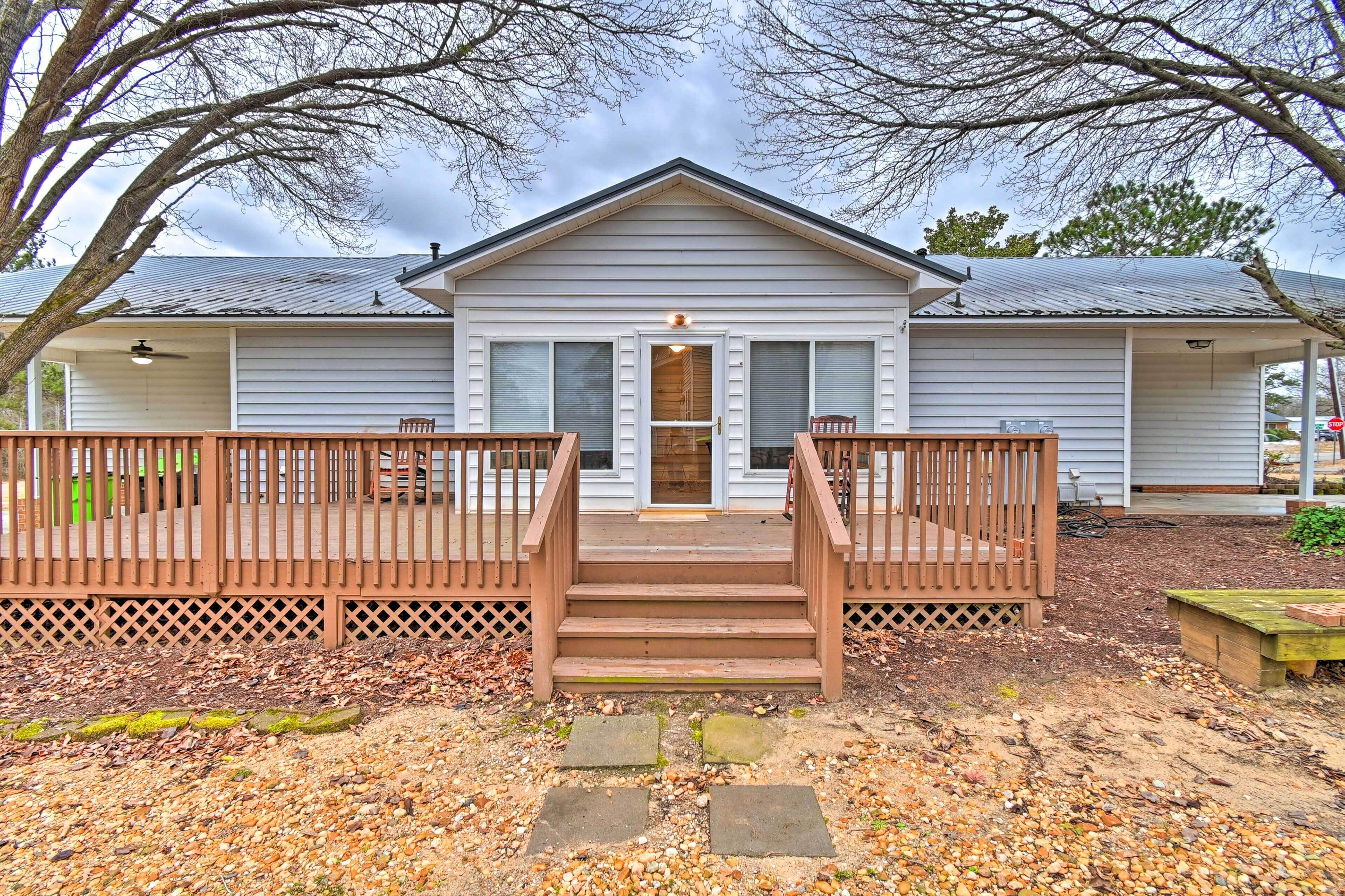 A two-story house with a front porch, a covered entryway, and a small deck area.