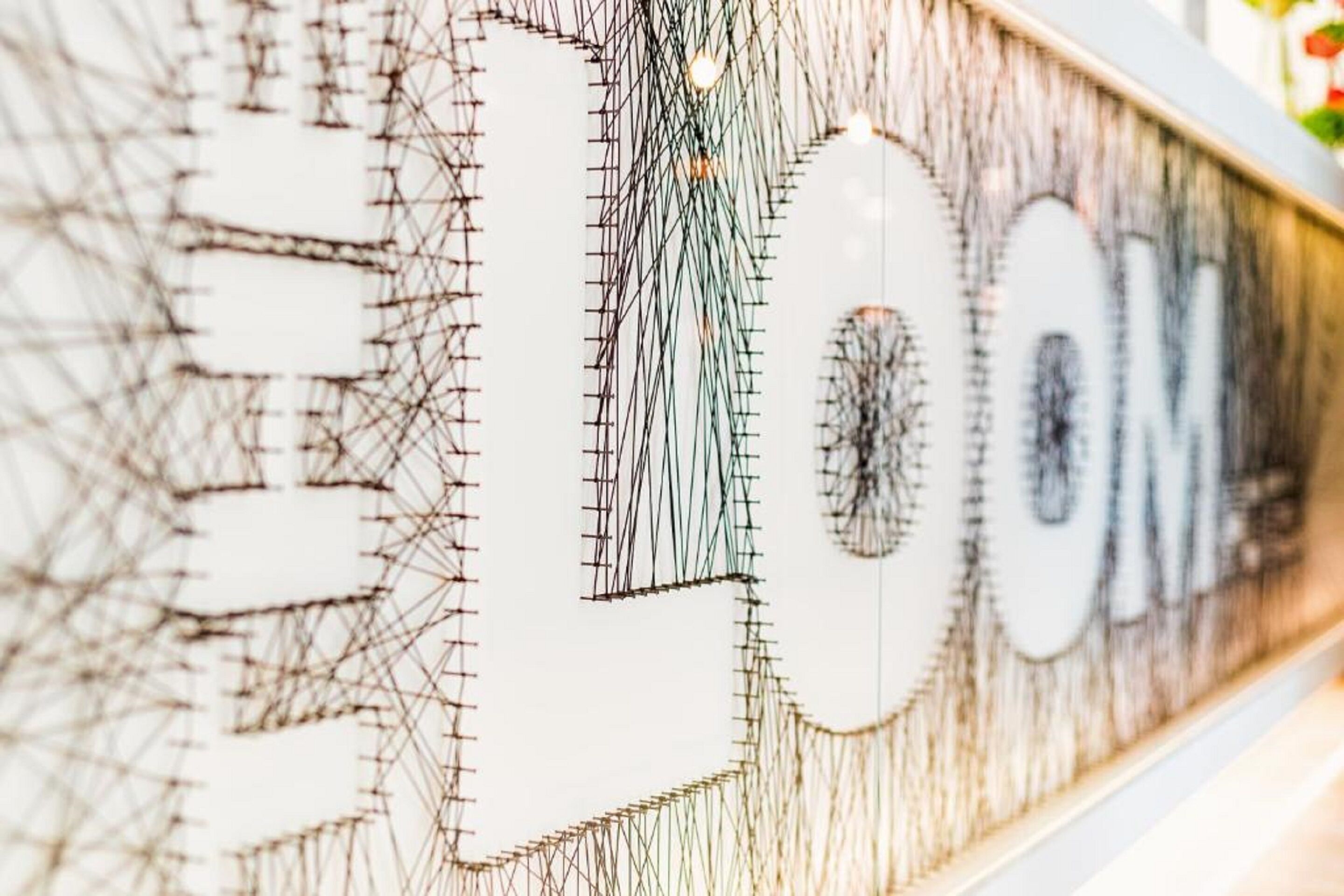 A close-up of a wall with a complex, abstract design featuring geometric shapes and lines.