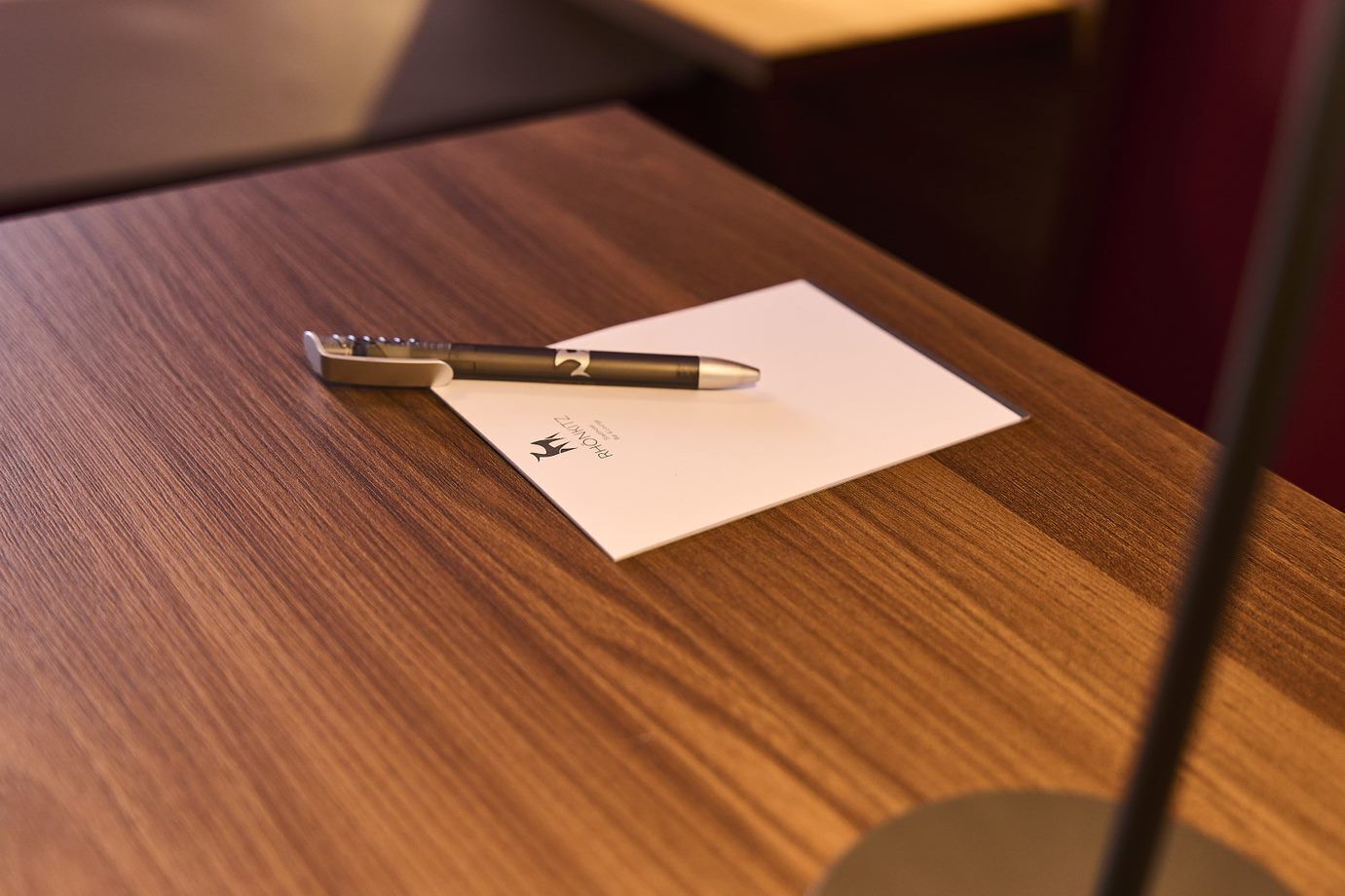 A pen on a piece of paper on a wooden table.