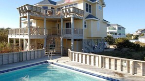 A multi-story house with a balcony and a swimming pool. - 2060 - DoodleBug - Corolla Retreat | Private Pool & Walk to Beach (Corolla)
