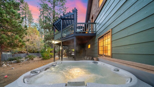 A hot tub in a backyard with a wooden deck and a house in the background. - Family Retreat: Near Town, Hot Tub, AC, (Idyllwild)
