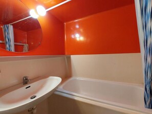 A bathroom with a white sink, a mirror, and a bathtub. - Ski-in/ski-out & foot of the slopes, 1st floor, view resort, tv, 33m², Les Arcs (Les Arcs)