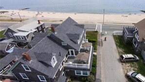 A residential area with houses, a beach, and a road.
