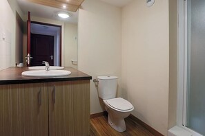 A bathroom with a wooden vanity, a white sink, and a toilet. - 100m from resort center, 2nd floor, jacuzzi, hammam, balcony, parking, tv, ski locker, 59m² (Germ)