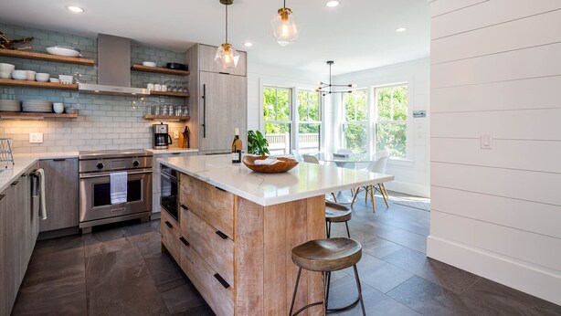 A modern kitchen with a central island, stainless steel appliances, and wooden accents. - Exquisite 3 bedroom home in a great location! RPSH005 (Provincetown)