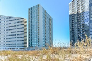 Situated in an urban coastal area, this high-rise building features a grid-like pattern of windows.