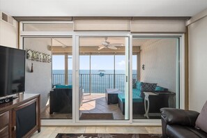 Relax on the balcony with a sofa, table, and chair, and enjoy the view from the sliding glass door.