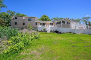 A row of modern, two-story houses with a shared backyard and white fences. - Elevate Your Cape Stay: Chatham Luxury with Pool & Beach RPAM026 (Chatham)